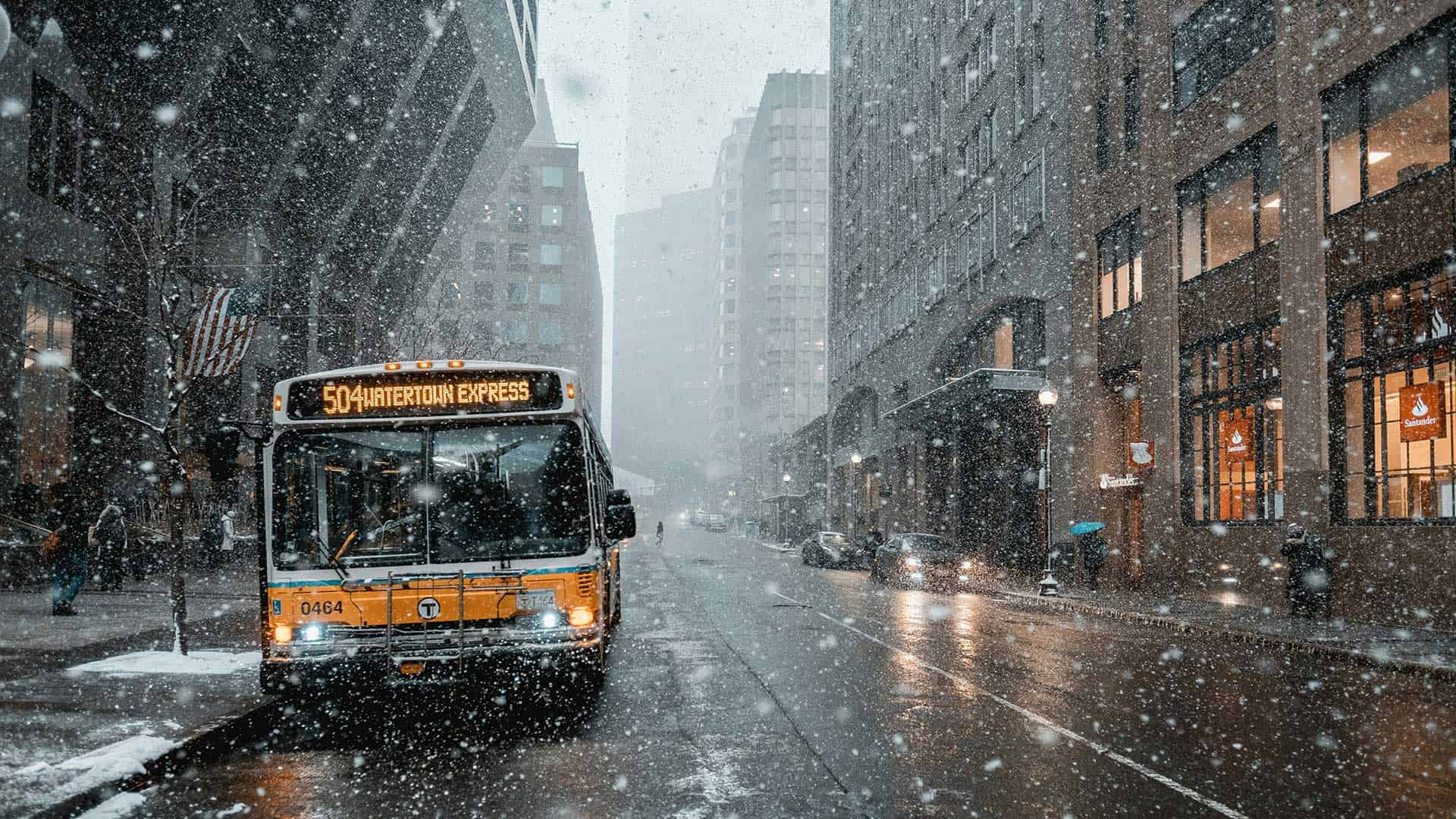 cold temperatures with snow in the city with a city transit bus